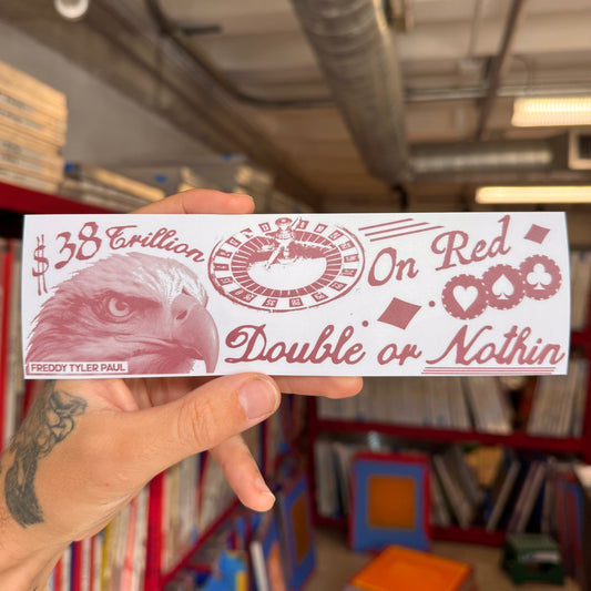 Hand holding a red and white card with an eagle design and text in a room with bookshelves.