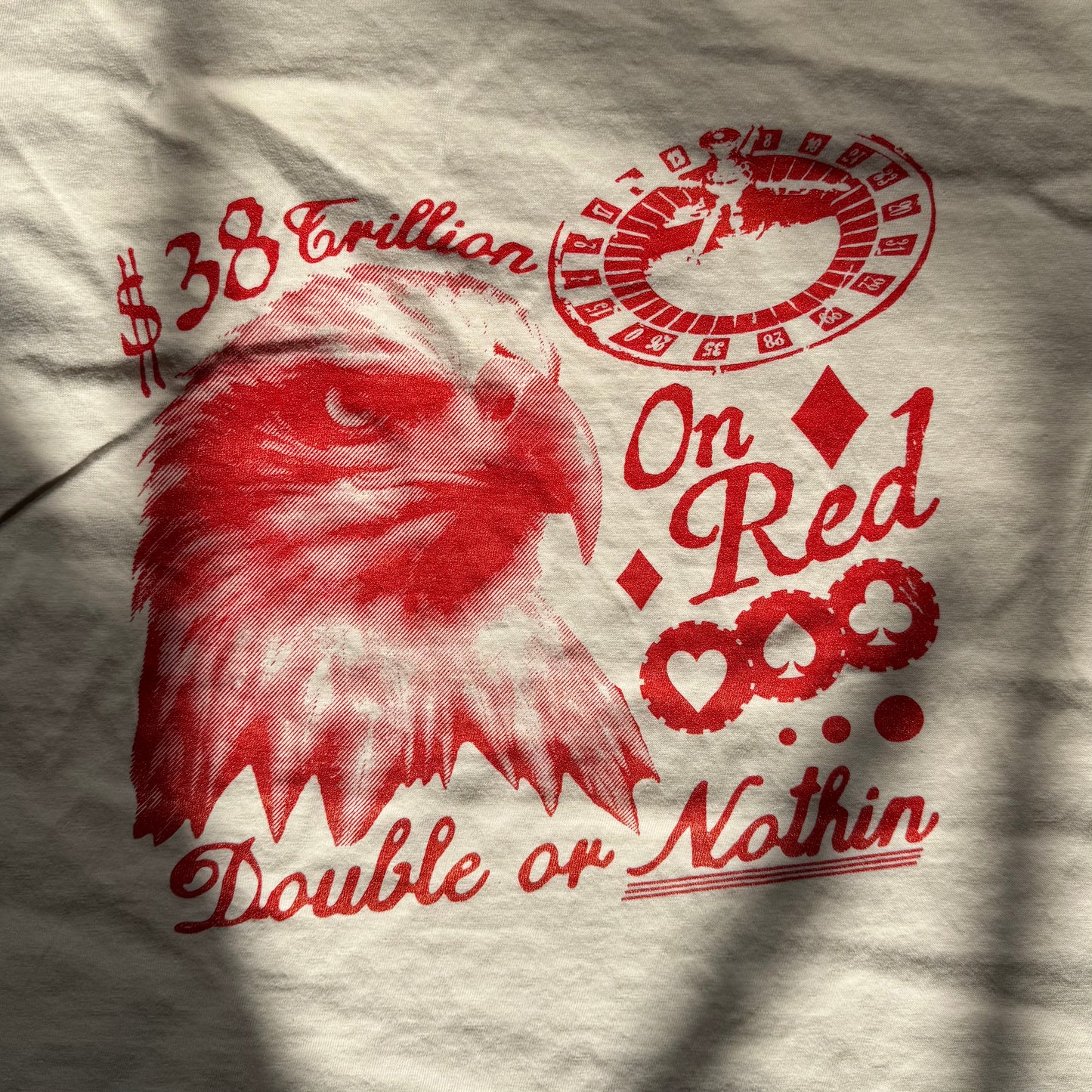 Gray t-shirt with red eagle graphic and text on a textured background