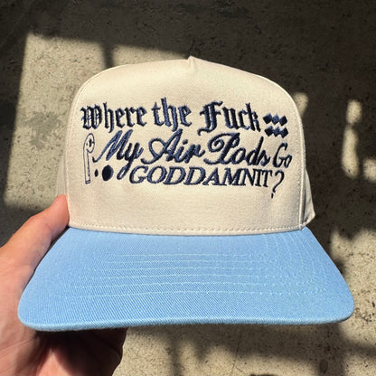 Cap with text held by a hand against a textured wall background