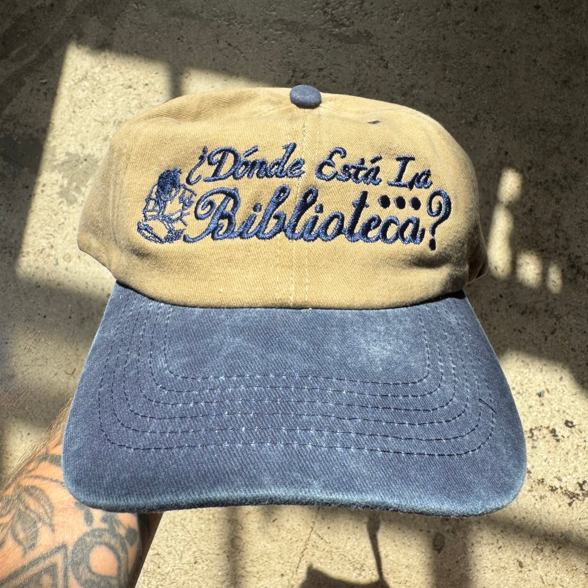 Beige and blue cap with text on a textured surface