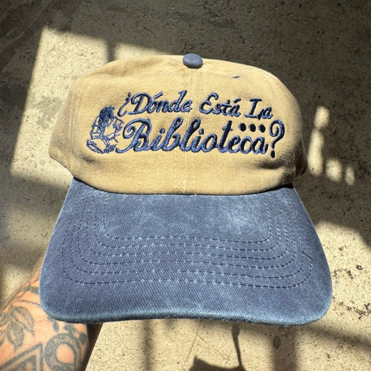 Beige and blue cap with text on a textured surface