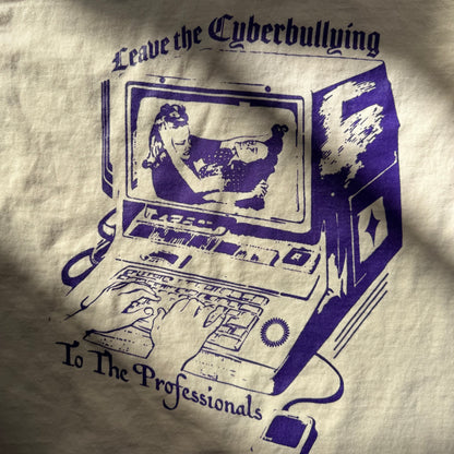 T-shirt with graphic design and text 'Leave the Cyberbullying to the Professionals' on a beige background