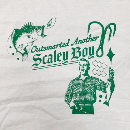 White t-shirt with green graphic design featuring a fisherman and text on a white background