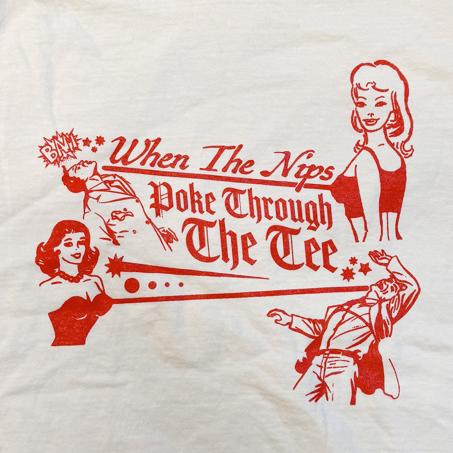 White t-shirt with red graphic and text 'When The Nips Poke Through The Tee' on a white background